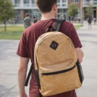 Person wearing a maroon shirt and Tyvek Printed Backpacks walking outdoors on campus.