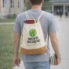 Someone with a Trendy Drawstring Bag carries books along a campus pathway.