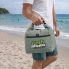 Man holding a Cooler Bags Bulk gray cooler bag on a beach.