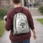 Person with a Personalised Silver Drawstring Bag walks toward a building.