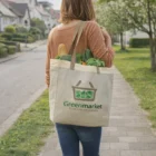 Woman carries Goodies Tote Bag with groceries and Greenmarket logo on the sidewalk.