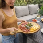 Homechef Serving Boards hold meats, crackers, and olives for outdoor gatherings.