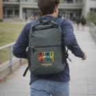 Someone with a Krakken Backpacks bag walks along a campus pathway.