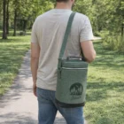 Man in Seattle park carrying a green Seattle Double Wine Chiller Bags Bulk.