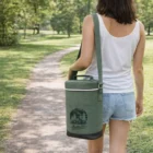 Woman in shorts with a green Seattle Double Wine Chiller Bag, walking on a park path.
