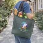 Person with groceries in a Fabs Shopper Heather Tote, reading Kidstalk Where fun begins.