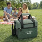 A green Marceille Cooler Bag with Your Logo, next to a family having a picnic.