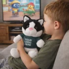 Young boy cuddles a Cat Personalised Plush Toy, logo showing, while watching TV.