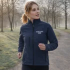 Woman jogging in a park wearing Sols Roxy Womens Softshell Jacket with Your Logo Here.