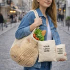 Woman carrying Folding Mesh Shopper Bags with groceries and two pouches labeled YOUR LOGO HERE.