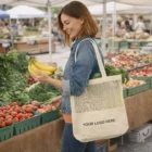 Woman at farmers market holding bananas, with Cannoch Cotton Tote Bags that say YOUR LOGO HERE.