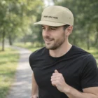 Man jogging outdoors in Hyndburn, wearing a black t-shirt and a Hyndburn Branded Cap.