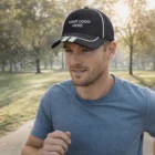 Man jogging in a park, wearing a Kash Caps hat and a blue t-shirt.