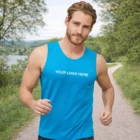 Man wears blue Sols Sporty Mens Tank Top with "Your Logo Here" outdoors on a path.