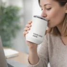Woman sips from a Camelbak Horizon Moscat Vacuum Tumbler 350Ml while working on her laptop.