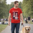 Man in Sols Pioneer Mens Organic T-Shirt walks a golden retriever in a lively park scene.
