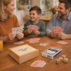 Family playing Berwyn Card Game Sets at a table, smiling, with dice and card box nearby.