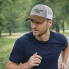 Man jogging outdoors in a navy shirt and a Galloway Corduroy Peak Cap that says YOUR LOGO HERE.