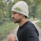 Man jogging outdoors in a gray Snowflake Acrylic Knitted Beanie and a black long-sleeve shirt.