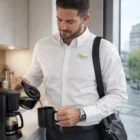 Man in a Trendswear Parker Men's Poplin Shirt pours coffee in a modern kitchen.