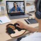 Woman on video call at desk using Full Colour Mouse Mats with a face and hair design.