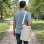 Man walking on a park path with Double Wine Cooler Bags, cream-colored, seen from behind.