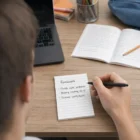 Student making a homework list with Caspian Office Note Pads A7 - Lines On One Side at a desk.