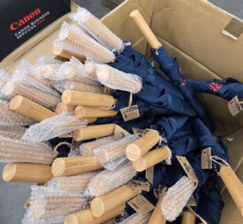 Box of umbrellas with wooden handles; Minimum Order Quantity applies to each order.