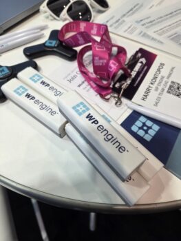 WP Engine swag—lanyards, USB drives, and pens—featuring the best logo format on display.