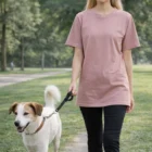 Woman in a Wo's Classic Tee walking a dog on a leash in the park.