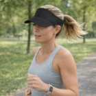Woman jogging in Norman Sports Ready Visors and a smartwatch.
