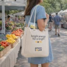 Woman with a Finlay Organic Cotton Canvas Carry-All Tote 13L at a lively farmers market.