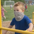 Young boy in blue shirt wears Aero Coolmax Bandanas – Kids; other kids play in the background.