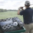 A golfer prepares to swing; Bridgestone Treo Golf Balls and a custom ball are in the foreground.