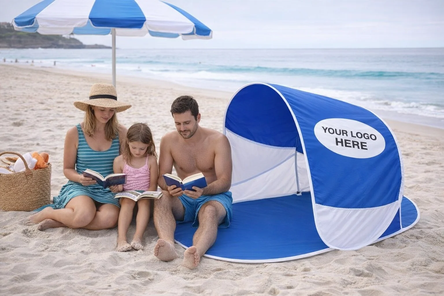 Family reading books on Bondi Beach under Bondi Beach Shades with custom Your Logo Here sign.