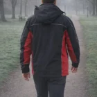 Someone in a 3 In 1 Custom Jacket walks down a foggy park path, seen from behind.