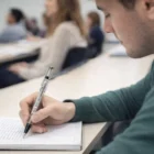 A student takes notes with a Lamy Vista Rollers pen during class.