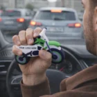 A man in traffic squeezes a Personalized Stress Balls - Bike showing Your Logo Here.