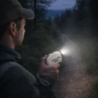 Person holding Rechargeable Torches lights a forest path at dusk with Your Logo Here.