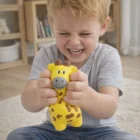 Child squeezes a yellow Stress Giraffes With Logo Printing toy indoors.