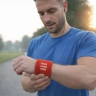 Man in blue shirt wears Terrycloth Elastic Wristbands 135mm on outdoor path.
