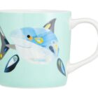 Light blue mug featuring a playful cartoon shark illustration on the side.