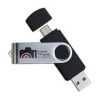 Black and silver USB flash drive with Frame 2 Frame Studios logo and dual connectors.