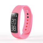 Pink digital fitness tracker watch displaying the time 20:38 on its screen.
