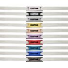 Ten white shoelaces with CUSTOM metal tags in different colors lined up vertically.