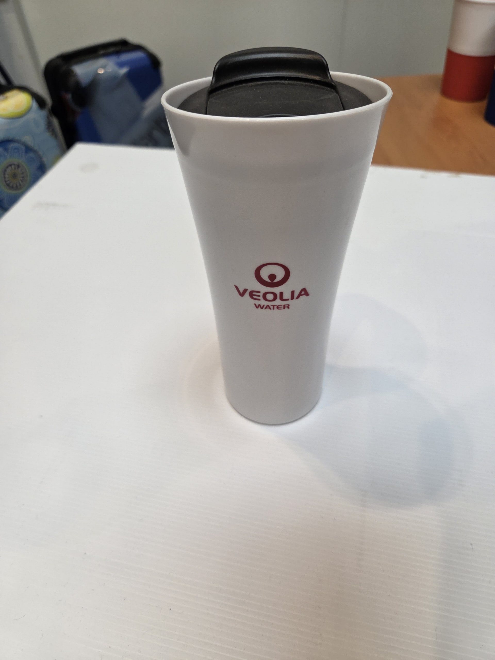 White VEOLIA travel mug—an ideal event essential and perfect for no size gifts.
