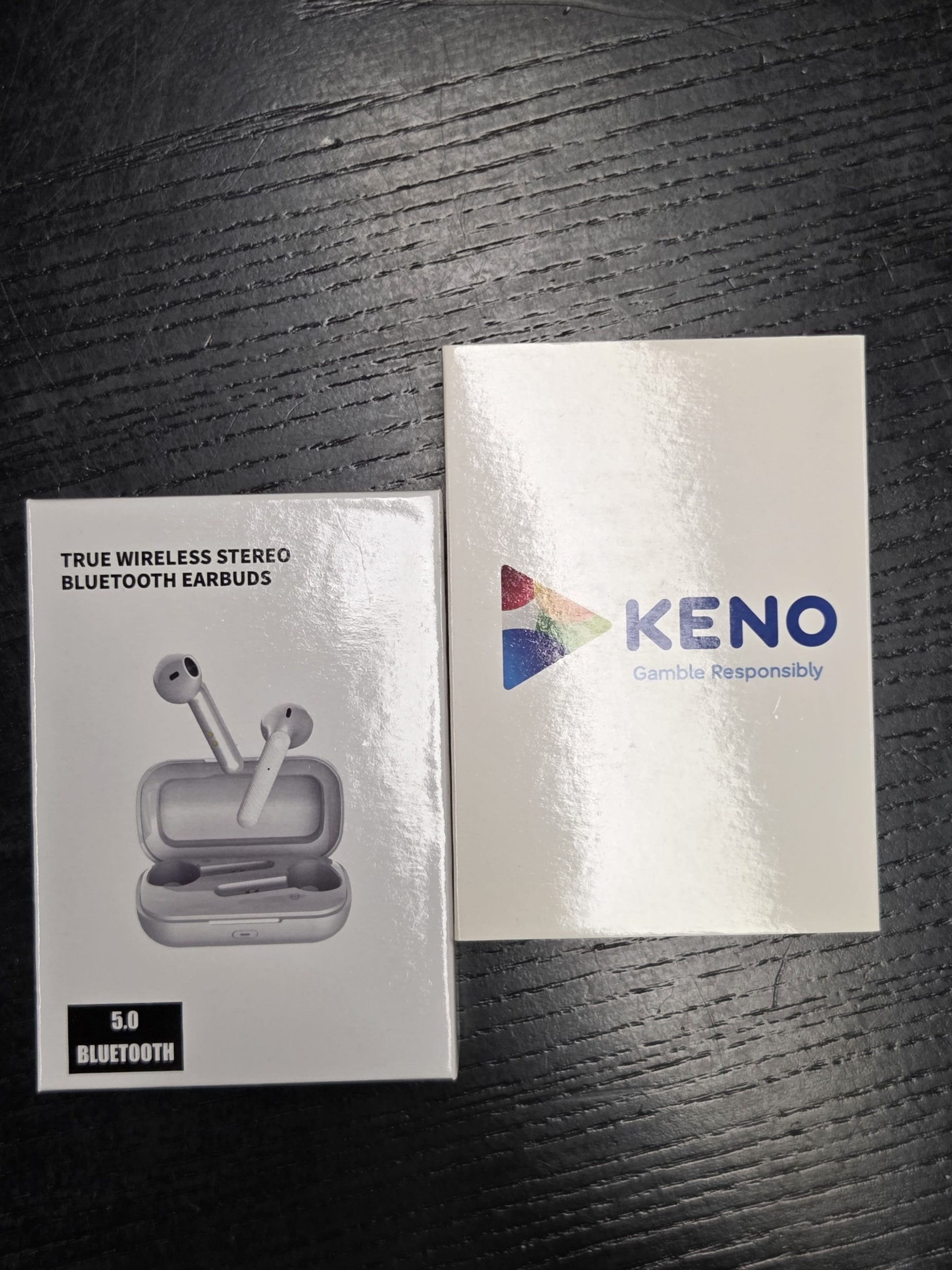 Two boxes on a dark table: perfect as 5 items for events, Keno and TWS Bluetooth Earbuds boxes.
