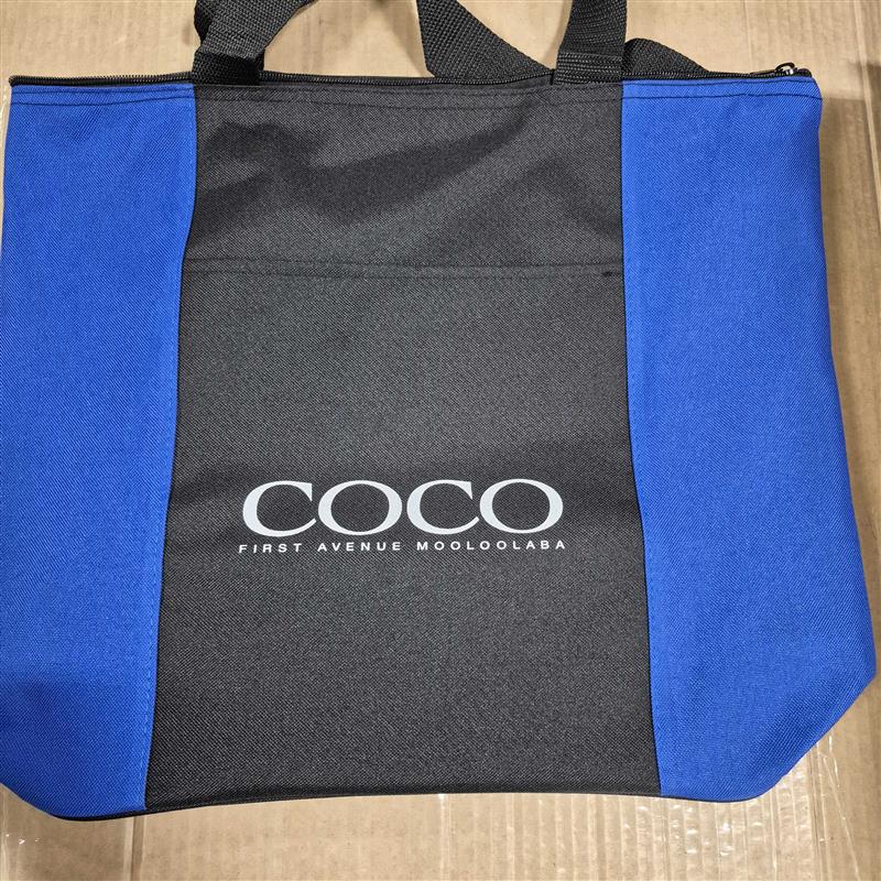 A black and blue tote bag—perfect for universal event gifts—with COCO FIRST AVENUE MOOLOOLABA.