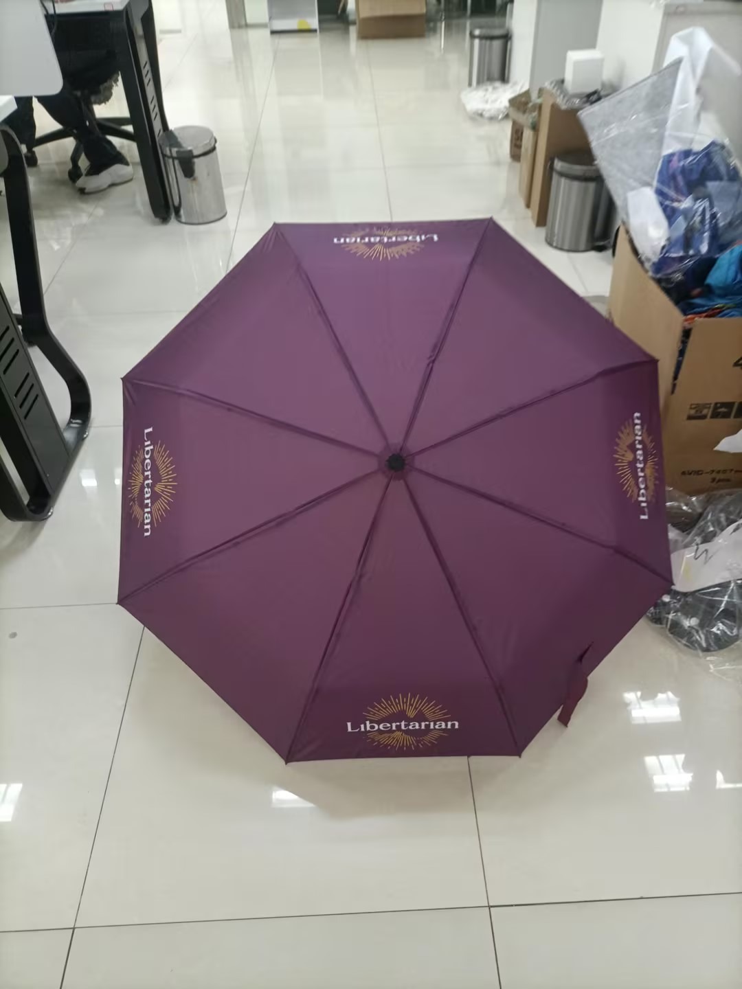 Purple umbrella custom branded with Libertarian Party logo