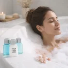 Woman relaxes in a bubble bath with Ocean Botanicals Range Custom Items labeled Your Logo Here.